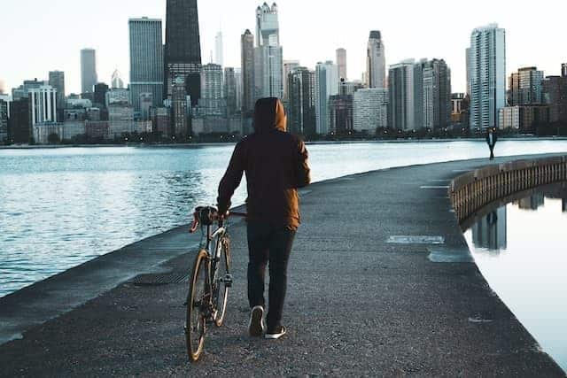 person walking their bike along Lake Michigan in Chicago bike tours