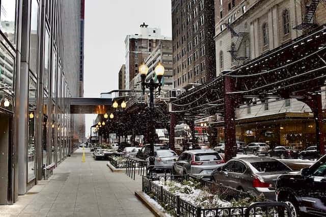 View of Chicago sidewalk and elevated train in winter