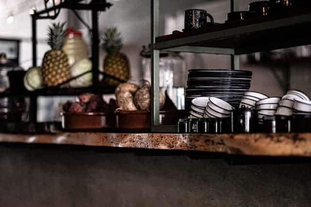 scene of a restaurant counter with clean cups and plates 