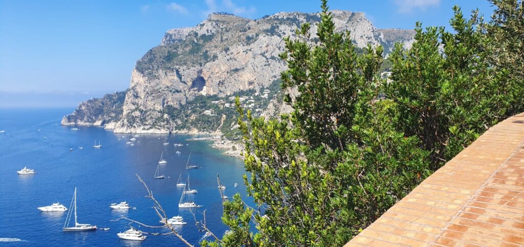 View of waters around Capri with sailboats against mountain background