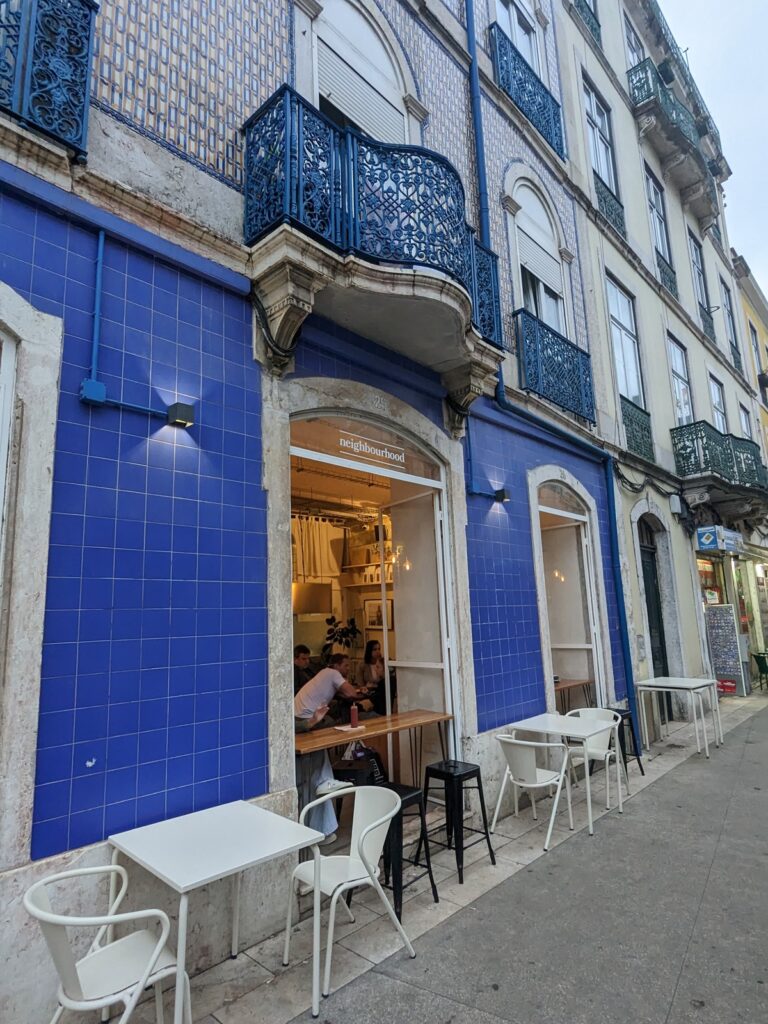 The Neighbourhood cafe in Lisbon, doorway amid blue walls