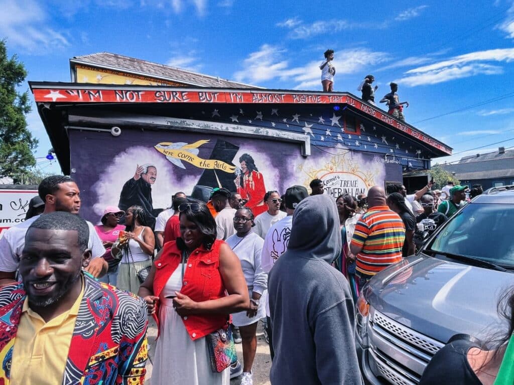 crowd of people in front of a mural in Treme, oldest african american neighborhood in usa