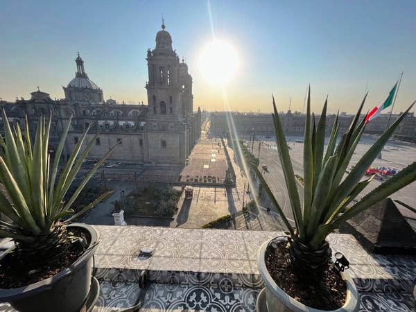balcony view over main square in Mexico City with sun shining in background