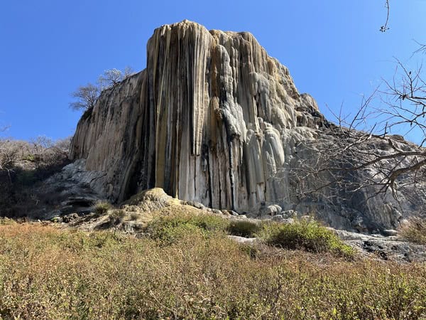 looking up at calcified waterfall which looks like a rock formation