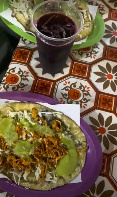view of a plate of traditional Mexican food and a red refreshing drink