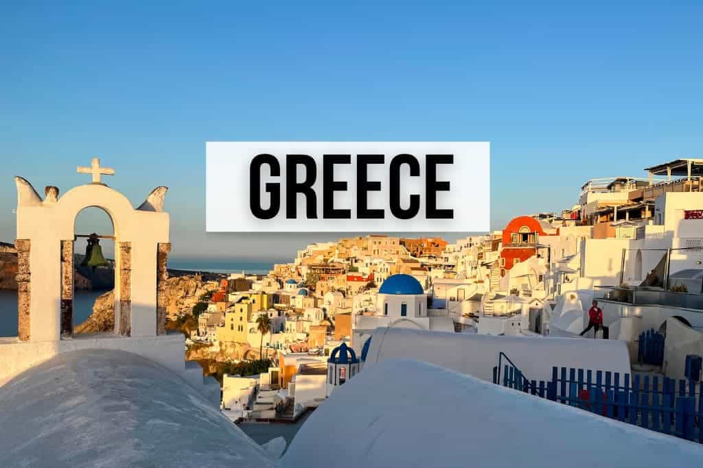 photo of Oia Greece at sunrise, an aerial view that shows whitewashed buildings, some blue domes and the sea in the distance. Rectangular, white section in middle has the words Greece in all caps