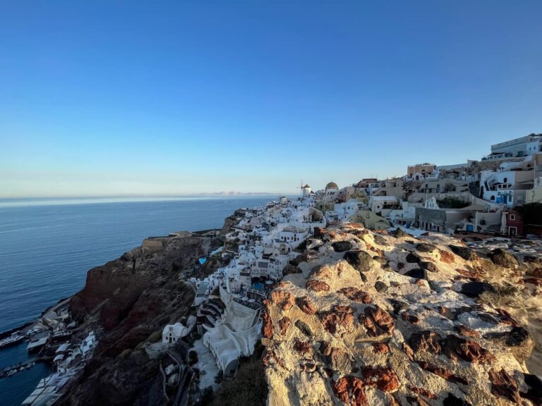 view over cliffside town to the right and blue sea to the left