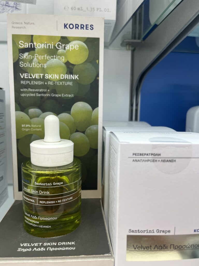 green glass bottle of Korres facial oil on display